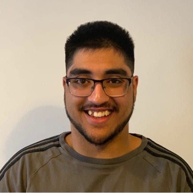 Smiling Camilo Piers wearing a grey top
