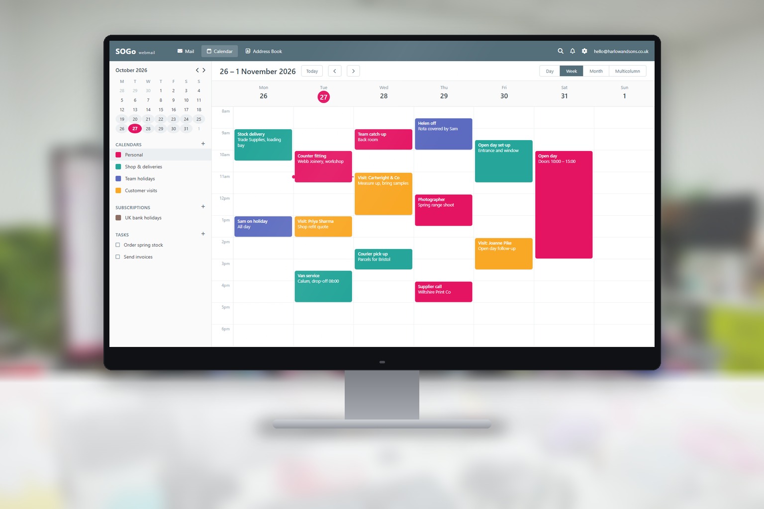 A desktop monitor in a bright office showing a SOGo calendar with a week of appointments