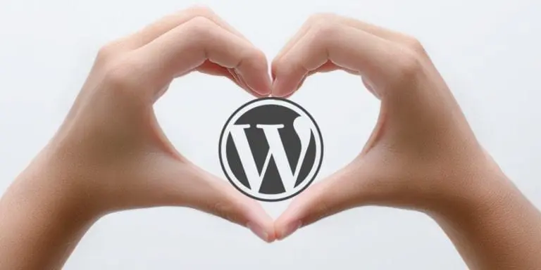 two hand making a heart image with a wordPress logo inside