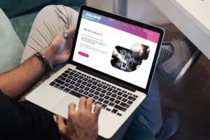 a person siting in a chair checking Vocavio website display on a laptop