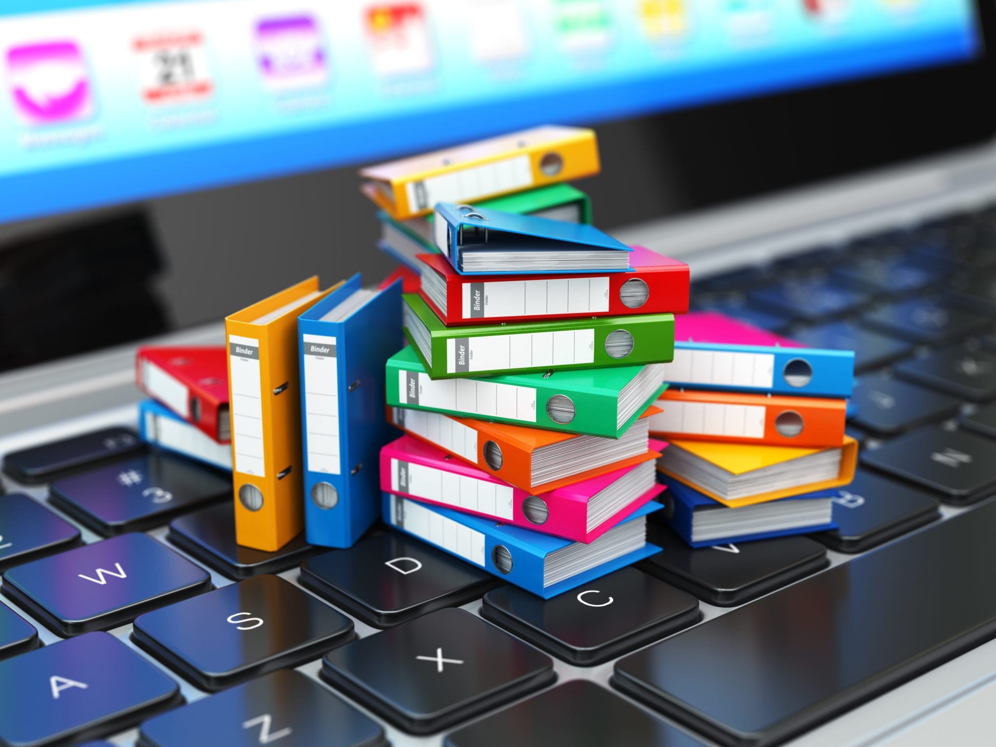 Colourful stack of folders on a laptop keyboard