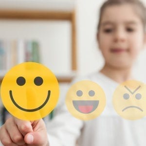 a girl selecting a happy face imoji