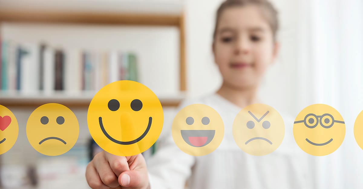 a girl selecting a happy face imoji