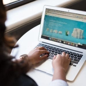 person typing on a laptop