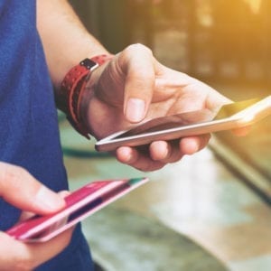 a person enter his credit card details on a mobile