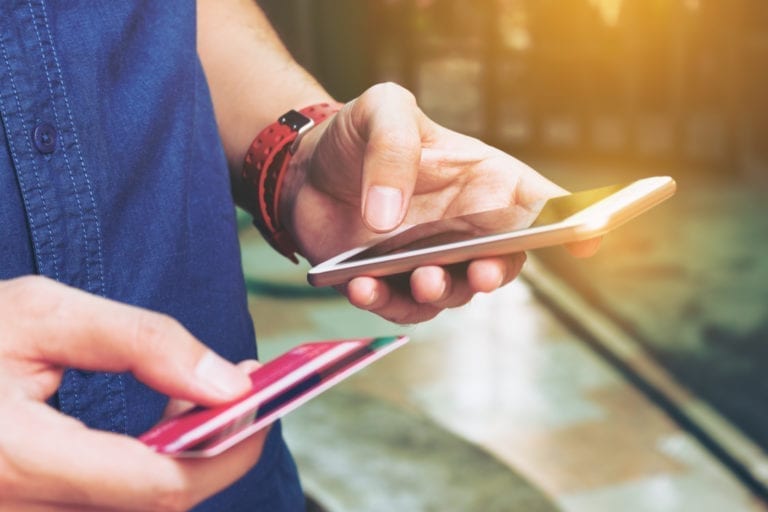 a person enter his credit card details on a mobile