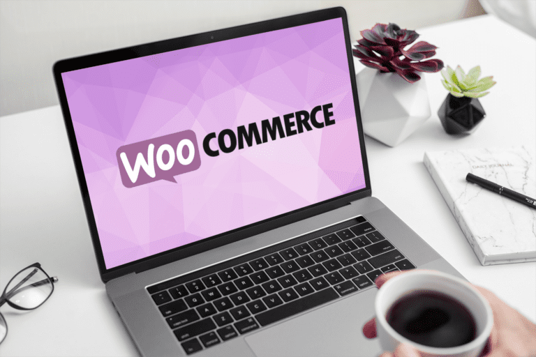 A person drinking coffee and watching WooCommerce website on a laptop