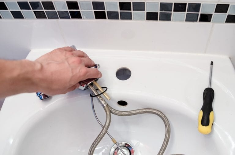 plumber fixing a sink
