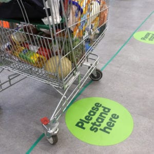 Social distancing marks on supermarket floor intended to stop spread of the contagious Coronavirus