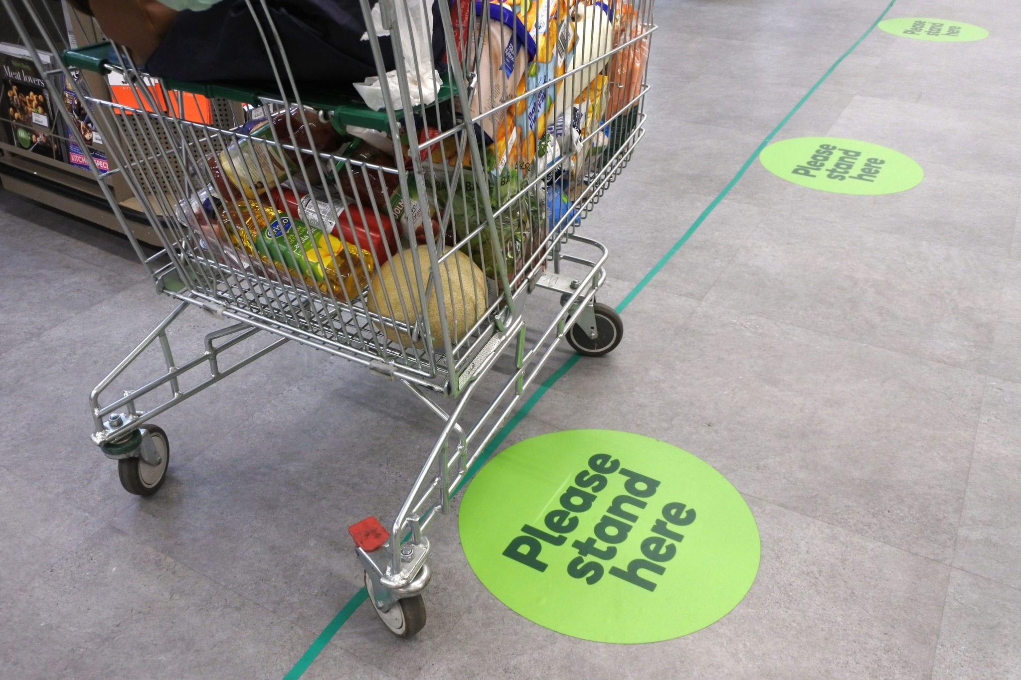 Social distancing marks on supermarket floor intended to stop spread of the contagious Coronavirus