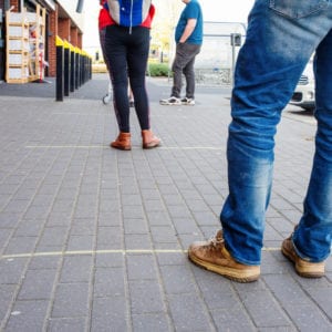 People (men and women) in a line / queue at the supermarket