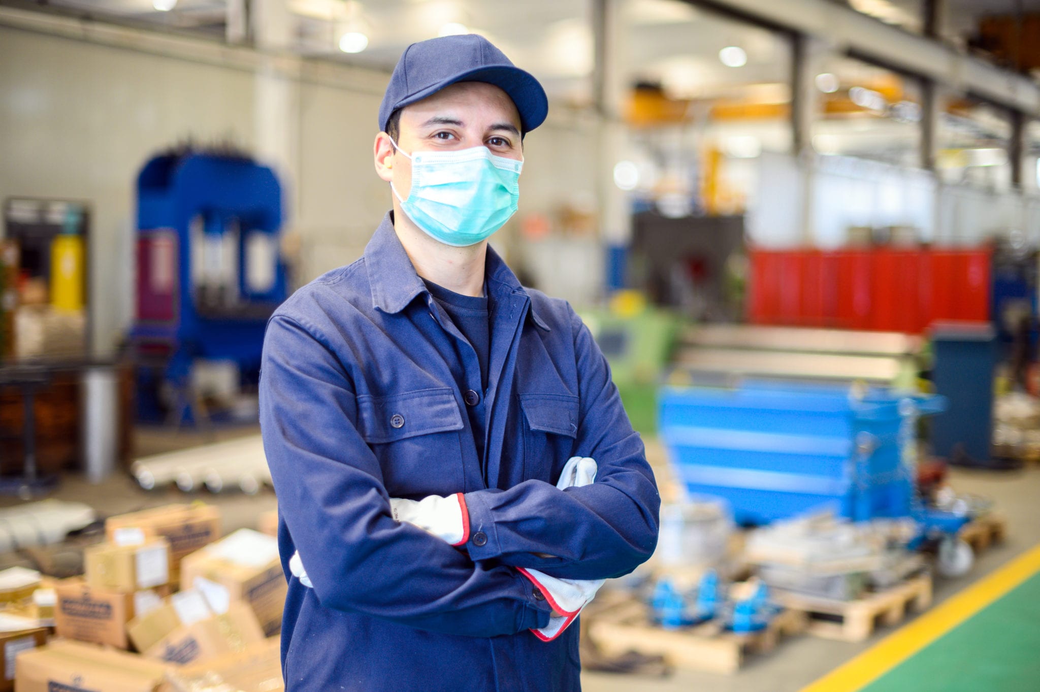 Portrait of a worker in an industrial plant wearing a mask