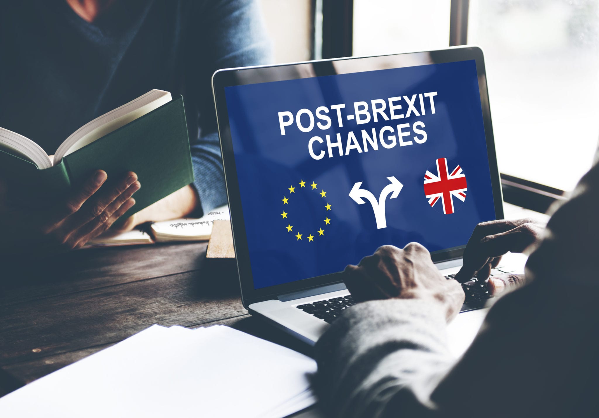 Laptop screen displaying 'Post-Brexit Changes' with EU and UK flags, symbolising trade and policy divergence