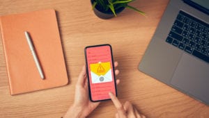 hand holding smartphone and show malware screen that comes with email