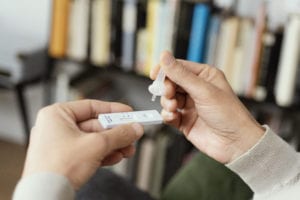a person use an antigen diagnostic test device