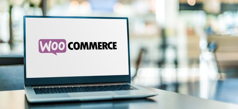 Laptop computer displaying logo of WooCommerce