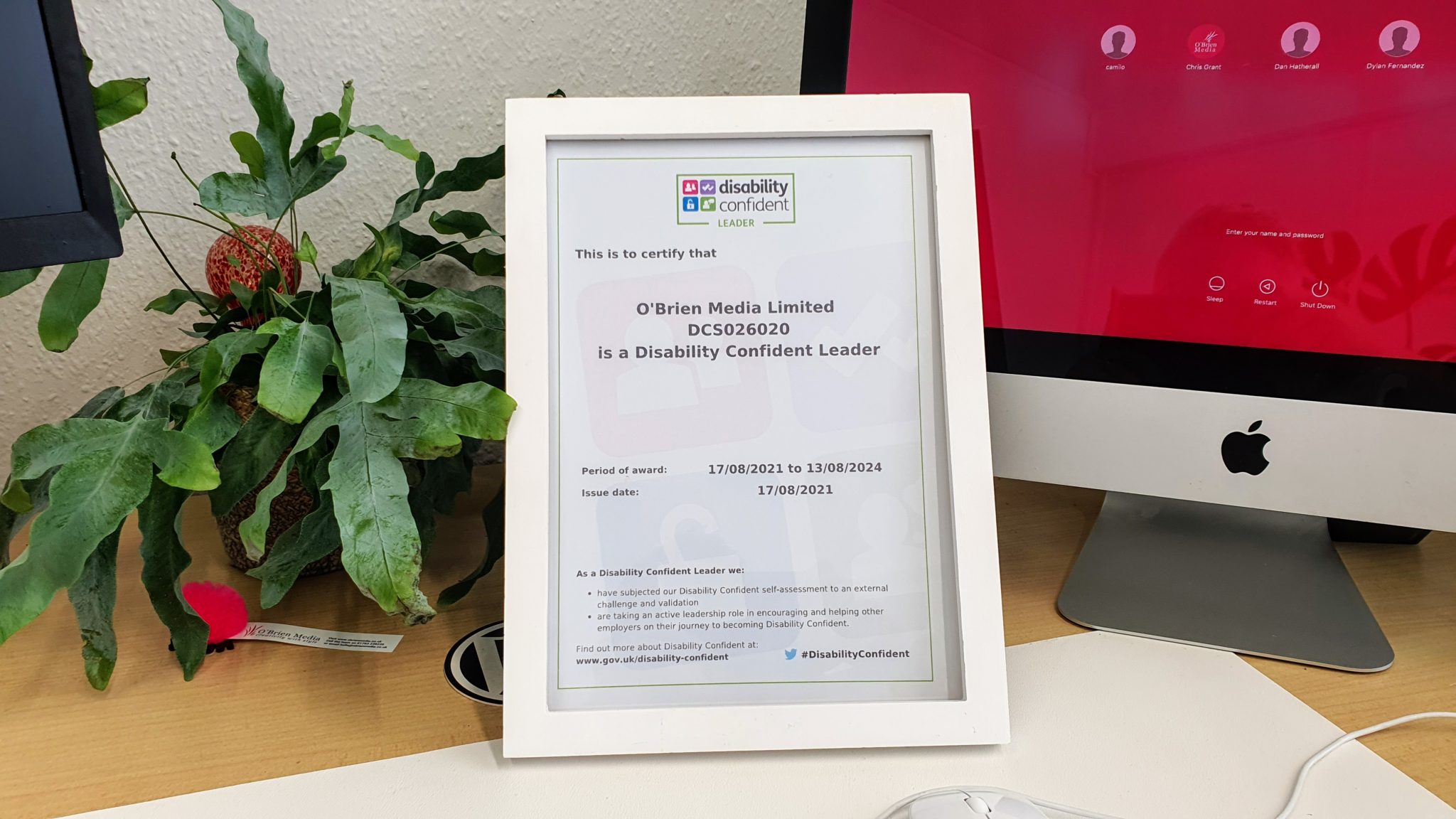 disability confident certificate on a desk next to a computer
