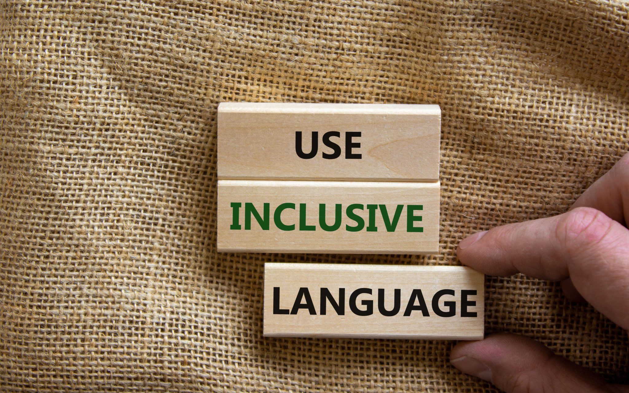 Use inclusive language symbol. Wooden blocks with words 'Use inclusive language'
