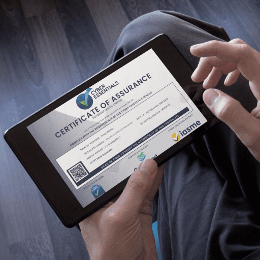 Professional holding a tablet showcasing O'Brien Media’s Cyber Essentials Certificate of Assurance, emphasising cybersecurity standards.