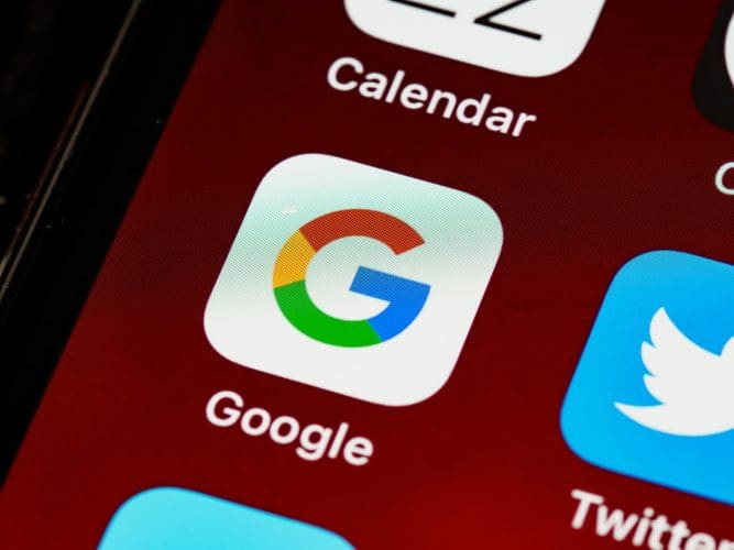 Close-up of a smartphone screen displaying the Google homepage