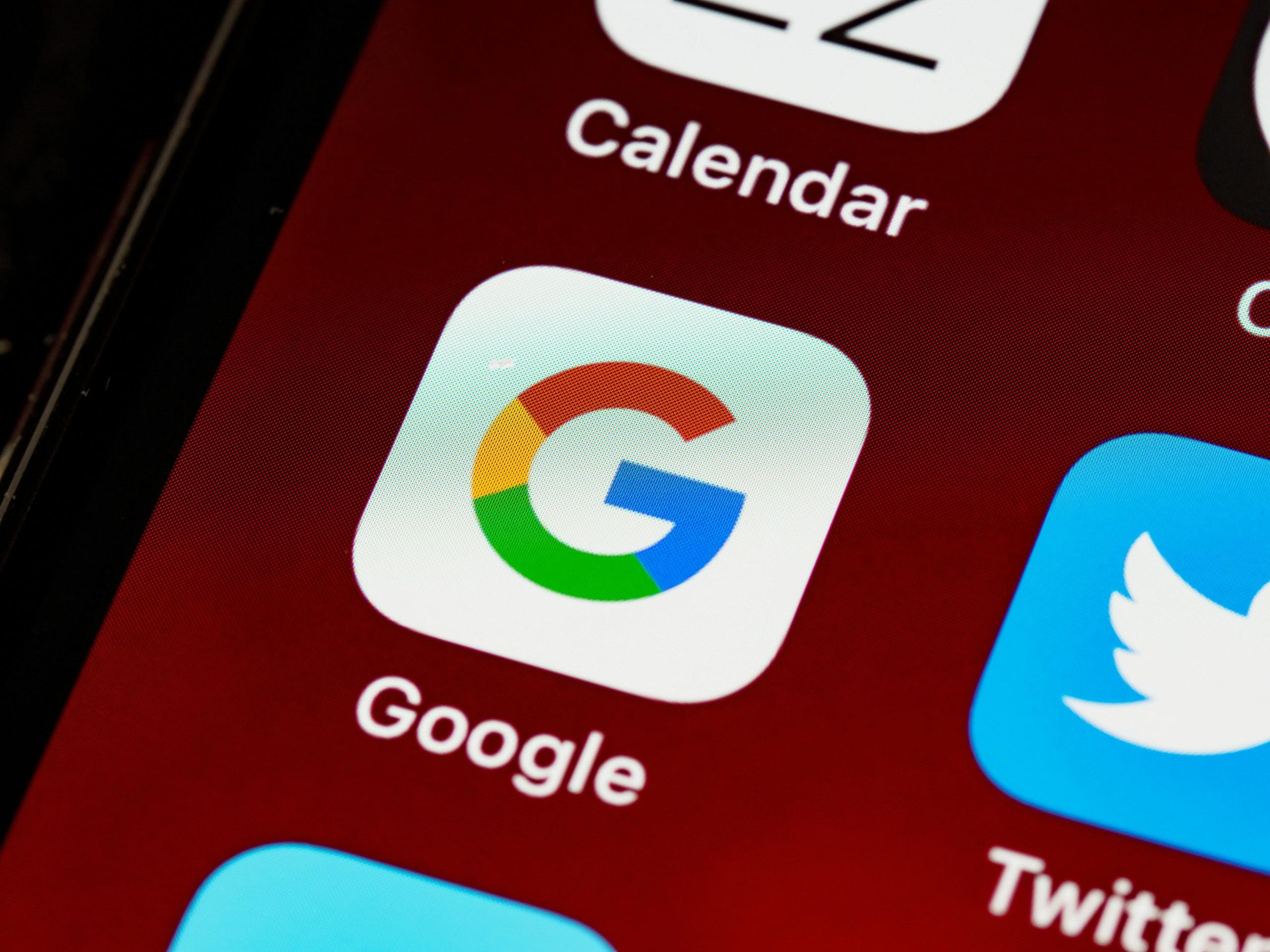 Close-up of a smartphone screen displaying the Google homepage
